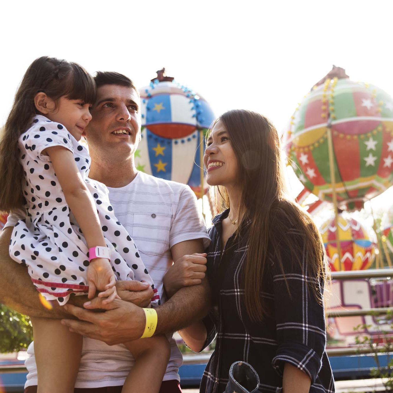 Happy family on holiday at the funfair